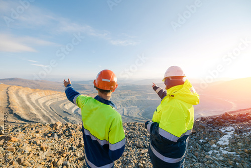 Fotografie Mining Engineers worker on Open Pit Quarry overlooking ore mine, back view