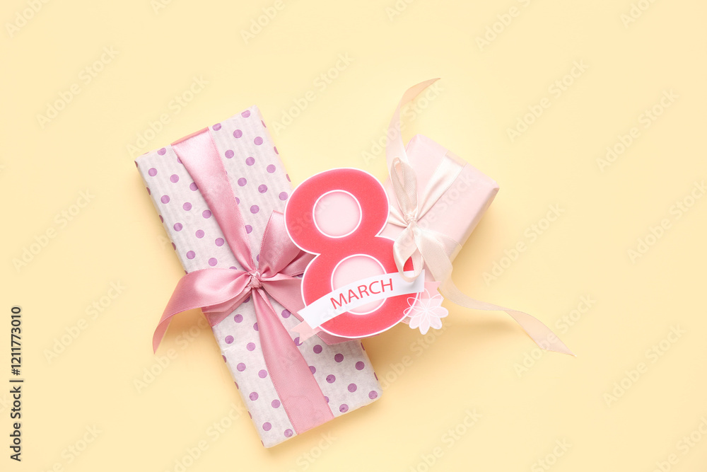 Composition with greeting card and gift boxes for Women's Day celebration on beige background Composition with greeting card and gift boxes for Women's Day celebration on beige background