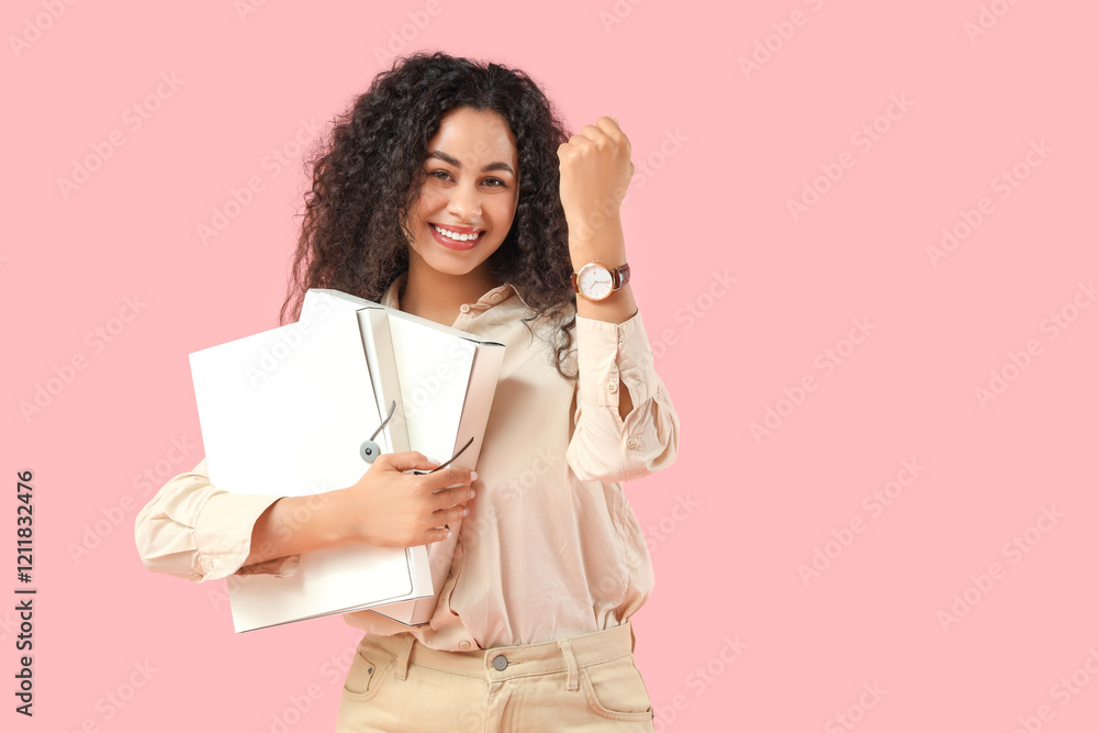 Young African-American woman with wristwatch and folders on pink background. Time management concept Young African-American woman with wristwatch and folders on pink background. Time management concept