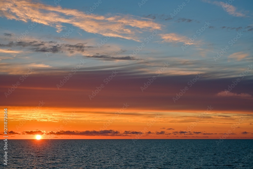 Gorgeous sunset. The sun is on the horizon. Beautiful clouds. Play of colors. Gorgeous sunset. The sun is on the horizon. Beautiful clouds. Play of colors.