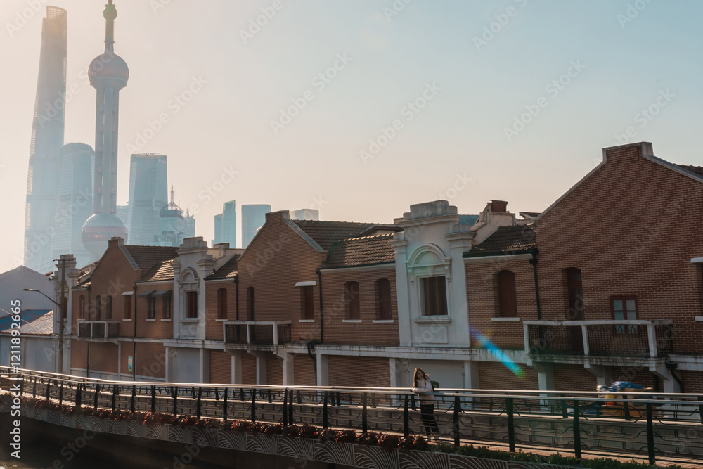 Fototapeta premium woman traveler visiting in Shanghai, China. Female Tourist with backpack sightseeing Shanghai view of Lujiazui in Hongkou Gang canal of Shanghai. landmark and popular for tourism attraction