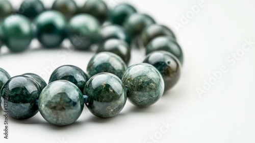 Green natural stone beads on a white background.  photo