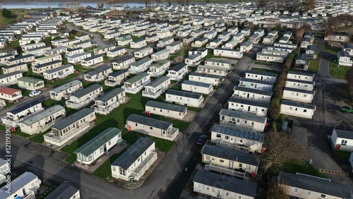 Aerial view of a large caravan park with rows of mobile homes set in a rural landscape