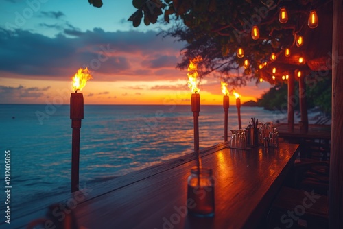 A wooden table set with candles next to the ocean, perfect for a romantic dinner or beachside gathering photo