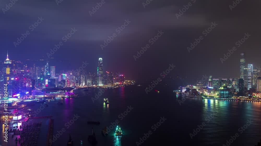 HONG KONG, CHINA - JANUARY 11, 2025: Stunning views of Hong Kong skyline illuminated at night with vibrant colors reflecting on water HONG KONG, CHINA - JANUARY 11, 2025: Stunning views of Hong Kong skyline illuminated at night with vibrant colors reflecting on water