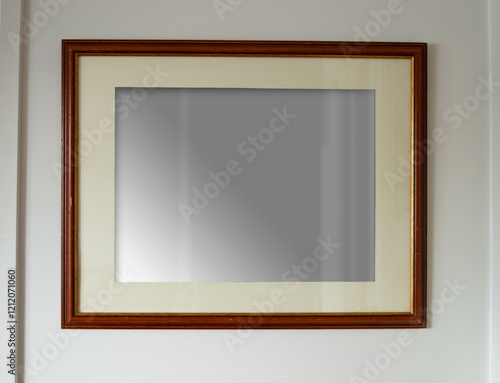 Wooden framed picture mocup. Blank wall art. Aged dark wood frame hanging on white wall. Poster picture in the interior