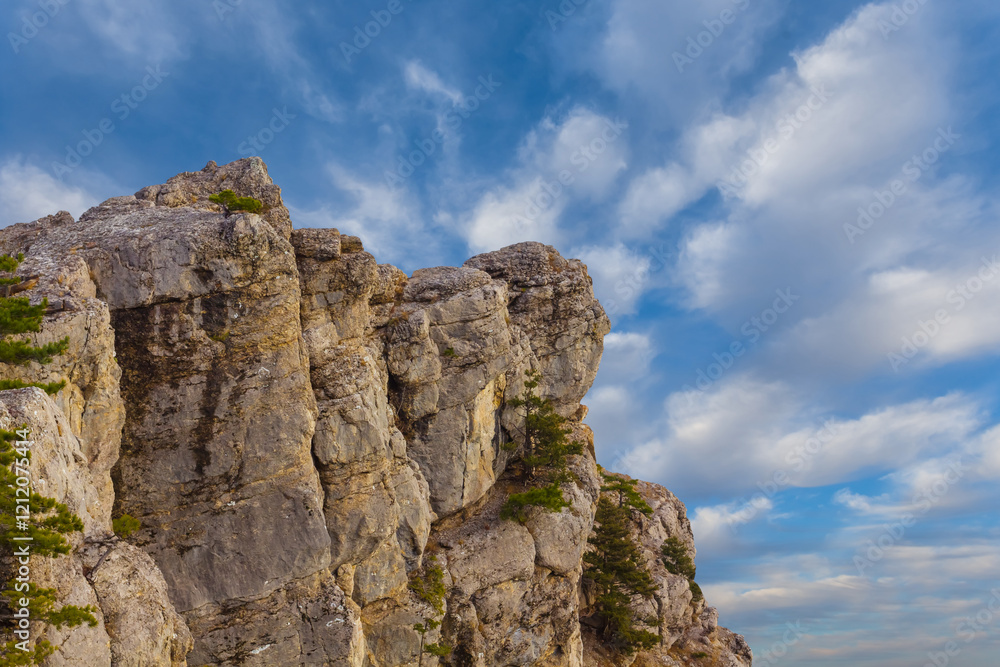 mountain cliff on the blue cloudy sky background mountain cliff on the blue cloudy sky background