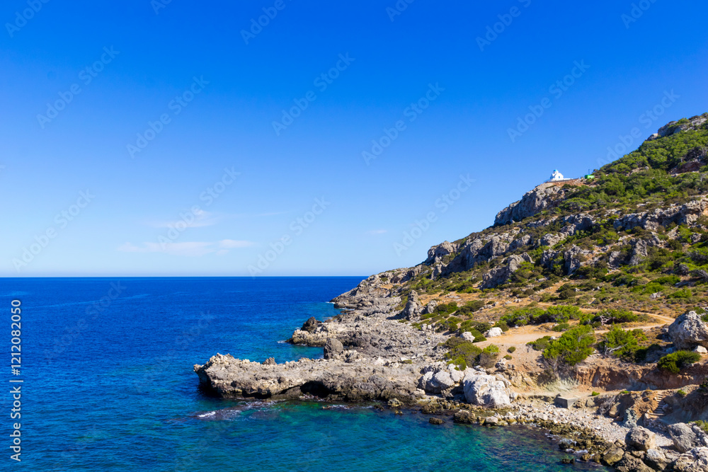 Panoramic view of west part of Karpathos landscape, near Pigadia, with small white chapel on the cliff, Greece