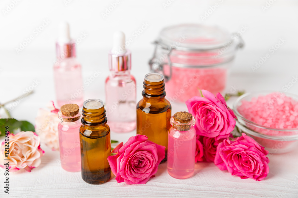 Rose essential oil on a textured background.Roses and a bottle of rose perfumed water.Aromatherapy treatment. Beauty concept. Spa procedure.Natural organic oil.Anti-stress,detox relax.Place for text Rose essential oil on a textured background.Roses and a bottle of rose perfumed water.Aromatherapy treatment. Beauty concept. Spa procedure.Natural organic oil.Anti-stress,detox relax.Place for text