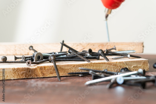 Photos Close-Up of Screws and Drill on Wooden Surface