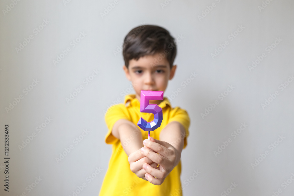 Portrait of happy five-year-old child with candle number five. Celebrate 5th Happy birthday. Party. Portrait of happy five-year-old child with candle number five. Celebrate 5th Happy birthday. Party.