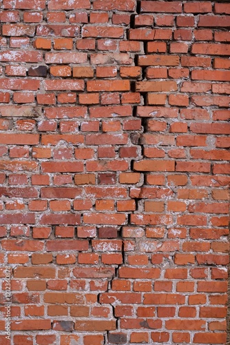 Red brick wall texture background. Brick wall with scratches and cracks. Background of old brick wall.