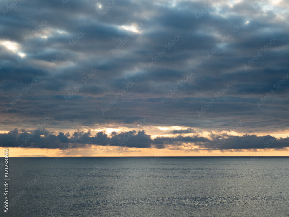 Fototapeta premium Sunrise over the ocean with clouds