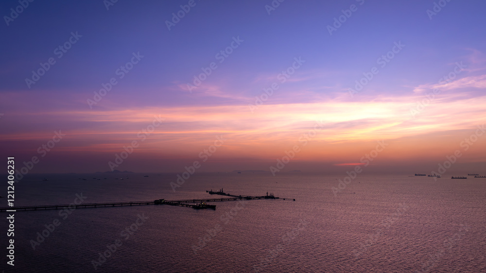 Fototapeta premium twilight of seascape and bridge crude oil and gas station in sea.