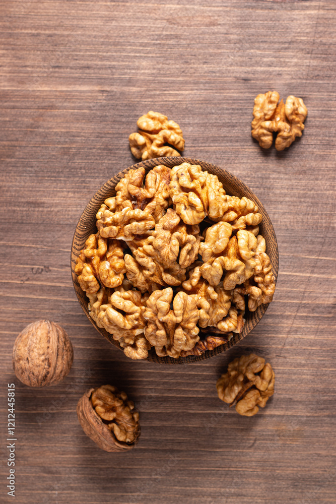 Walnuts nuts in a bowl on wooden background Walnuts nuts in a bowl on wooden background