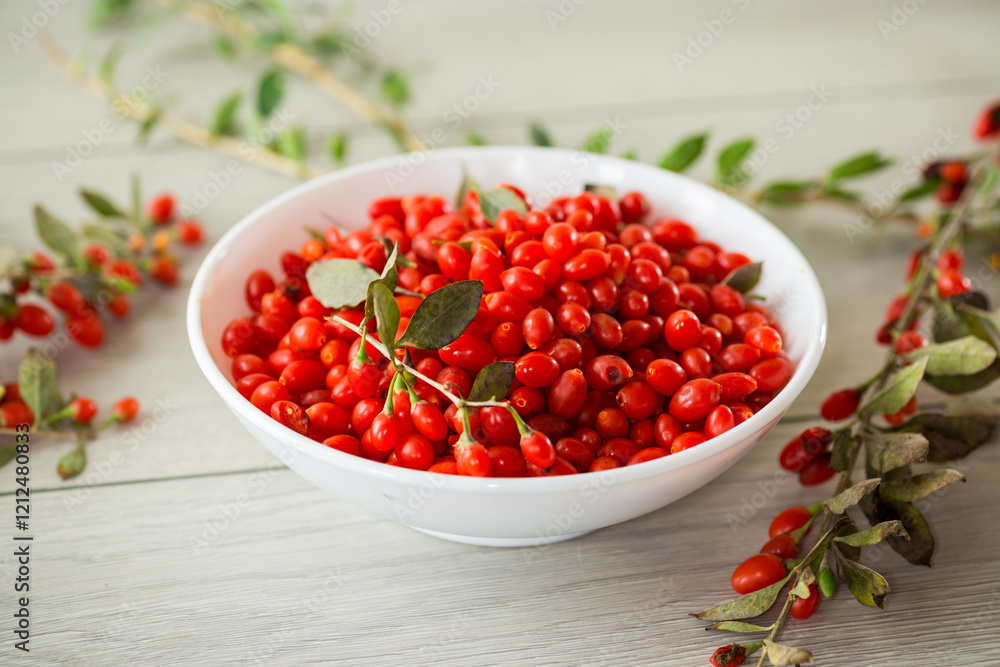 fresh ripe red goji berries in a bowl on a wooden table fresh ripe red goji berries in a bowl on a wooden table