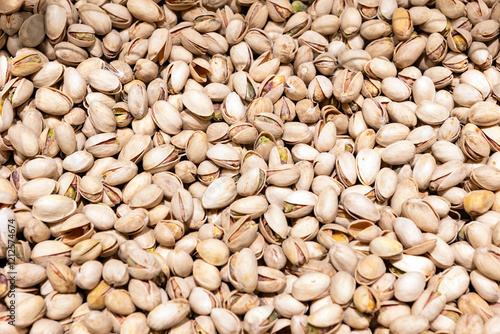 Food background with  closeup of a bunch of pistaches nuts in shell