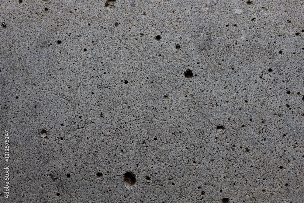 A detailed texture of raw gray concrete with cracks and small imperfections. Concept of industrial design. Suitable for backgrounds, architectural visuals, and graphic design projects. A detailed texture of raw gray concrete with cracks and small imperfections. Concept of industrial design. Suitable for backgrounds, architectural visuals, and graphic design projects.