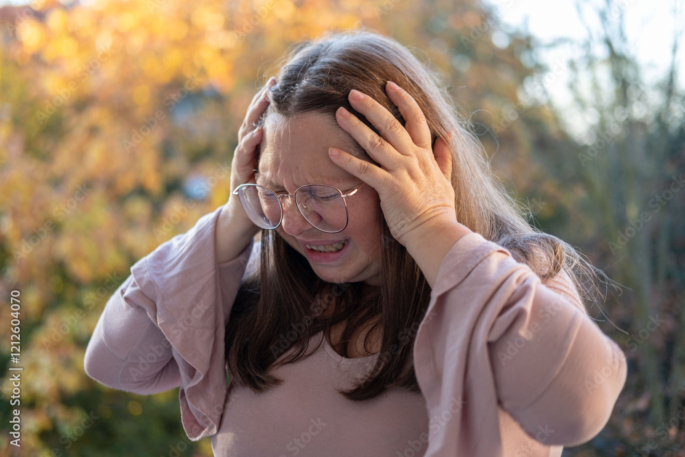 mature woman suffering from severe migraine, holding head in pain, pained expression, migraine attack, close-up distressed face, emotional struggle mature woman suffering from severe migraine, holding head in pain, pained expression, migraine attack, close-up distressed face, emotional struggle
