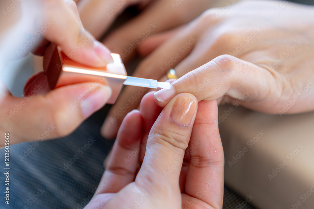 The manicure coats nails with gel polish in the beauty salon The manicure coats nails with gel polish in the beauty salon