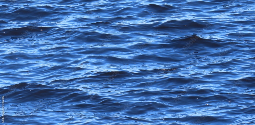 Fotografie Natural blue river water surface with soft waves as a background