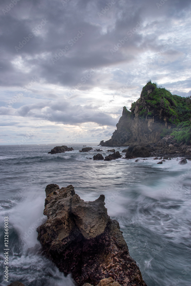 Long exposure of waves crashing against the rocks on a beautiful beach in Gunung Kidul, Yogyakarta. Long exposure of waves crashing against the rocks on a beautiful beach in Gunung Kidul, Yogyakarta.