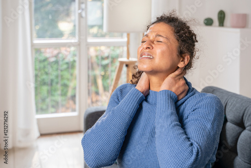 Black woman suffering neckache because of bad posture photo