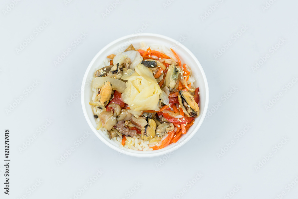 egg noodles, onions, bell peppers, mushrooms, carrots, seafood, mussels, squid, pickled ginger, sesame seeds in a white plate on a gray background egg noodles, onions, bell peppers, mushrooms, carrots, seafood, mussels, squid, pickled ginger, sesame seeds in a white plate on a gray background