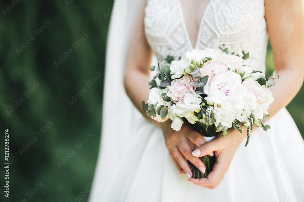 Bride holding big and beautiful wedding bouquet with flowers Bride holding big and beautiful wedding bouquet with flowers