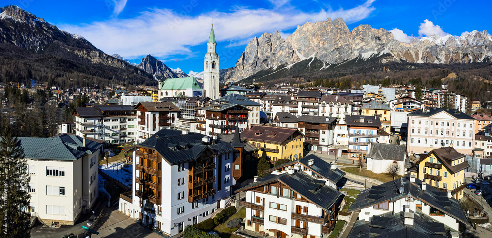 Italy, Cortina d'Ampezzo- famous luxury ski resort and beautiful town . aerial drone panoramic view of downtown surrounded by Dolomites mountains