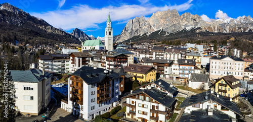 Obraz na płótnie Italy, Cortina d'Ampezzo- famous luxury ski resort and beautiful town . aerial drone panoramic view of downtown surrounded by Dolomites mountains w salonie