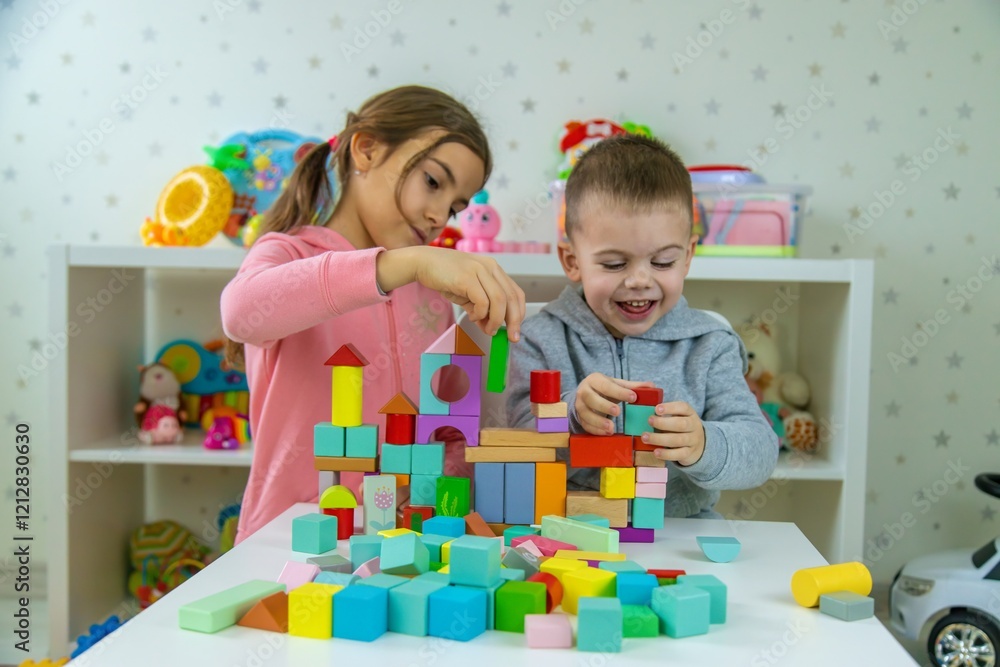 Fototapeta premium Children playing with toys in the room. Selective focus