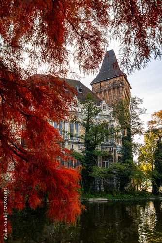Vajdahunyad Castle from the main city in Budapest surrounded by lush greenery and reflecting in the water. A fairytale-like architectural gem. Travel to Hungary during autumn.