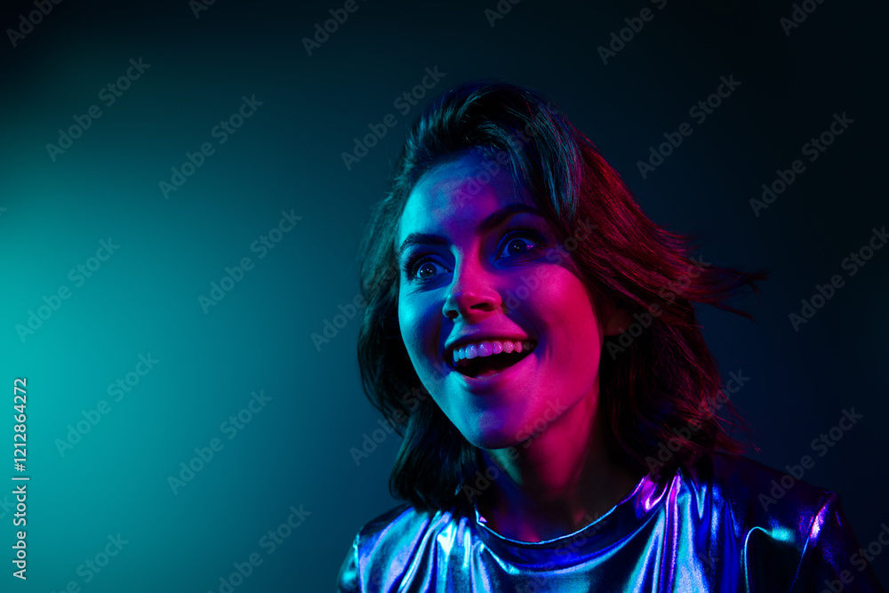 Fototapeta premium Portrait of stunning young woman look empty space ad wear shiny dress neon light dark blue background