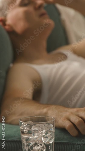Man sitting next to an electric fan