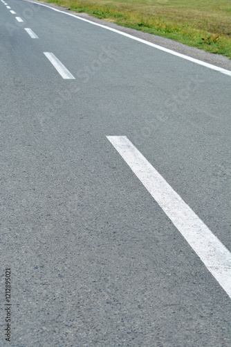 Wallpaper Mural An asphalt road with dashed white lines marking traffic lanes Torontodigital.ca