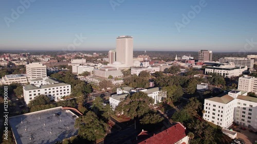 Drone landscape aerial of capital city Tallahassee, Florida with capitol building, federal legislature chambers, and governor office along with buildings, university, apartments, offices, and roads
