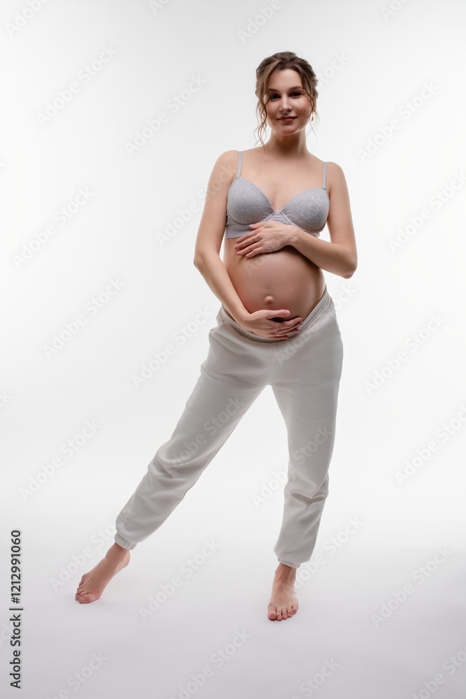 Φωτογραφία Beautiful pregnant woman poses in lingerie, showcasing her baby bump