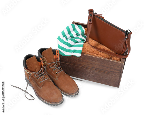 Crate with used clothes, bag and shoes isolated on white photo