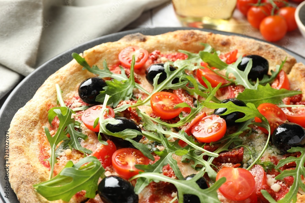 Tasty pizza with tomatoes, olives and arugula on table, closeup Tasty pizza with tomatoes, olives and arugula on table, closeup