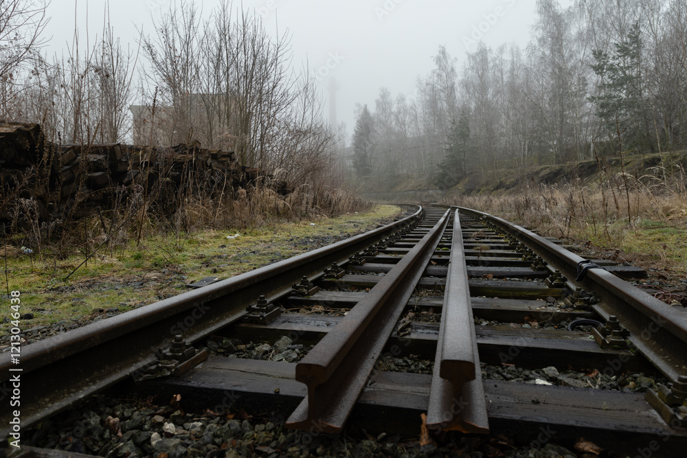 Abandoned rail tracks in an industrail zone covered in cold winter fog Abandoned rail tracks in an industrail zone covered in cold winter fog