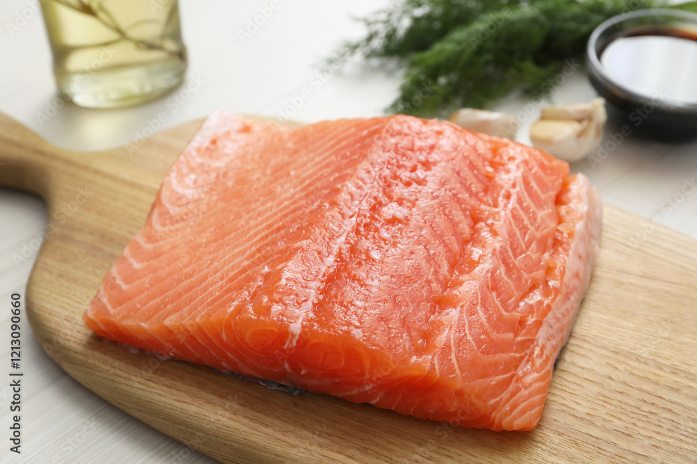 Salmon fillet and other products on wooden table, closeup Salmon fillet and other products on wooden table, closeup