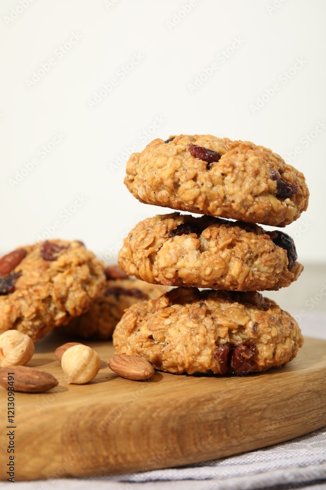 Delicious oatmeal cookies with raisins and nuts on table, closeup Delicious oatmeal cookies with raisins and nuts on table, closeup
