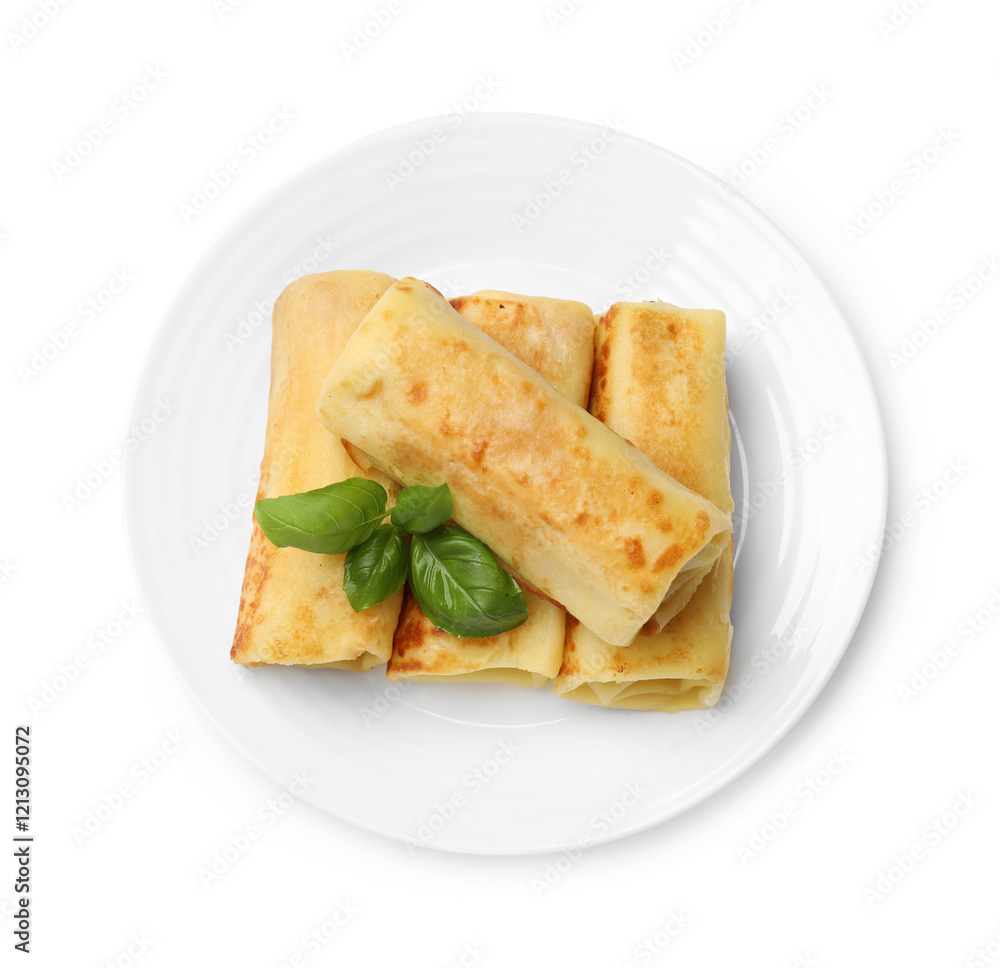 Delicious rolled crepes with basil isolated on white, top view Delicious rolled crepes with basil isolated on white, top view