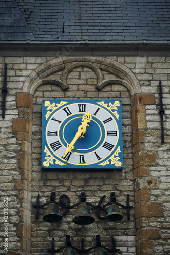 The clock and chimes on the east side of the town hall of Gouda, a historic city in the Netherlands. The building was made in the 15th century, while the carillon of the town hall dates from the 1960s photo