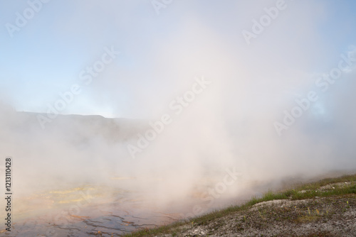 Steam rises off the hot sulphuric waters of the grand Prismatic springs of Yellowstone photo