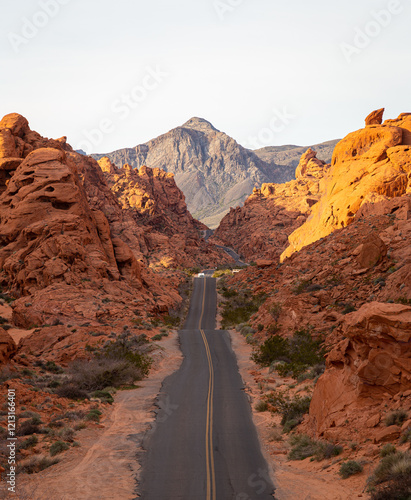 The sunrise light illuminates the red rock valley at Mouse Tank Road in the Valley of Fire state park in Nevada