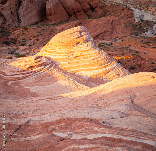 The sunrise light illuminates the patterns on the sandstone at the Fire Wave rocks in the Valley of Fire state park in Nevada