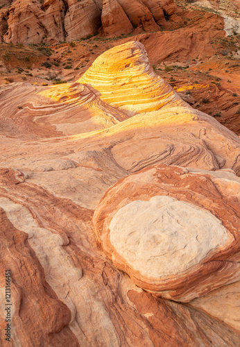 The sunrise light illuminates the patterns on the sandstone at the Fire Wave rocks in the Valley of Fire state park in Nevada