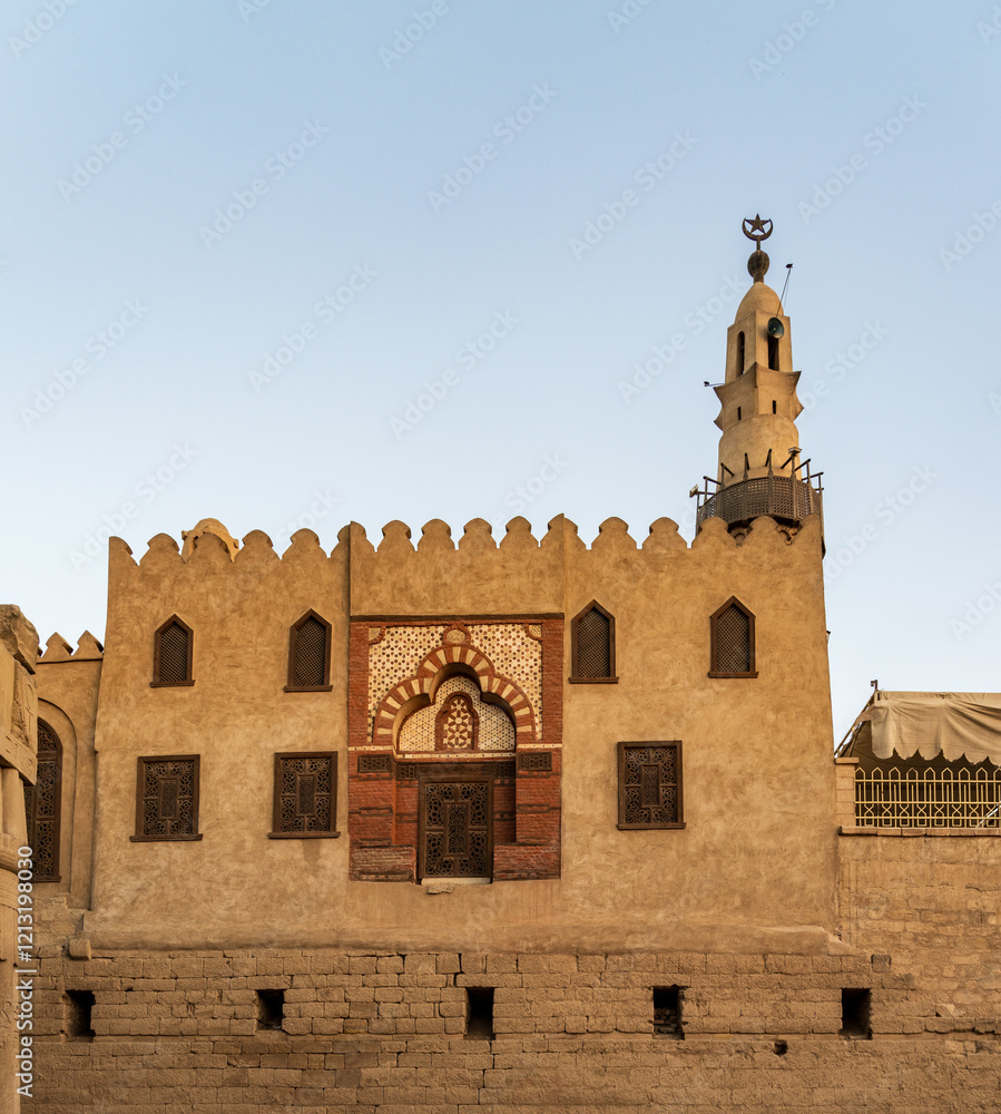 Fototapeta premium Abu Haggag mosque with a detailed entrance and a tall minaret under a clear sky and built inside the Luxor temple